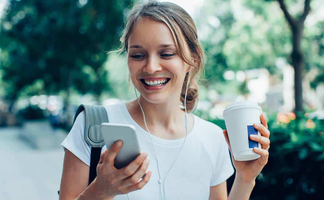 Woman-Smiling-On-Phone